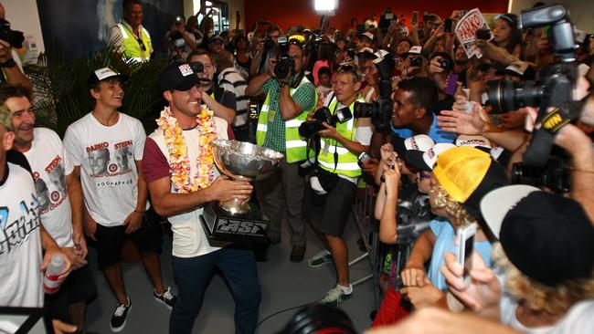 Newly crowned world champion Joel Parkinson is swamped by fans and the media as he arrives at Coolangatta airport in 2012.