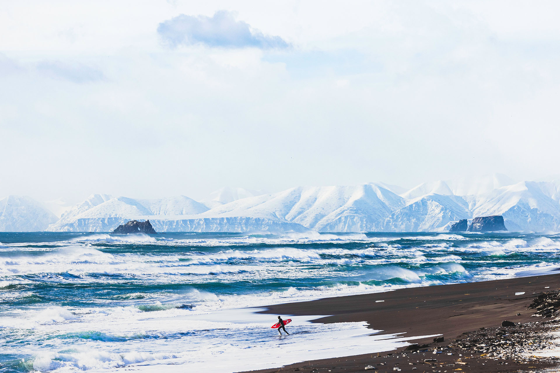 <p><em>Waves off Khalaktyrsky Beach in Kamchatka. Image credit: Guy Williment</em></p><p>&nbsp;</p><p>It’s late afternoon in Abu Dhabi, and two surfers from Sydney’s Northern Beaches are sitting in an aeroplane that’s been stuck on the tarmac for close to three hours. The plane was bound for Moscow, but it’s February 23, 2022 and news has just broke that Russia has invaded Ukraine. The surfers, <a href="https://www.instagram.com/lettymortensen/">Letty Mortensen</a> and <a href="https://www.instagram.com/fraserdovell/">Fraser Dovell</a>, are with two of their best mates, the filmmaker <a href="https://www.instagram.com/spencerfrostfilms/">Spencer Frost</a> and photographer <a href="https://www.instagram.com/guywilliment/">Guy Williment</a>. The pilot has just announced that the flight will continue through to its destination, and after three years of planning a mid-winter surf trip to the remote and largely unsurfed Russian peninsula of Kamchatka, the crew has about one hour to decide whether or not they’ll remain on the plane and fly, or pull the plug on the entire thing. </p><p>&nbsp;</p><p>While they’re waiting, Williment snaps a photo of Mortensen. Face mask on, eyes closed and hands in a prayer formation, it says everything you need to know about the intensity of the situation. </p><p>&nbsp;</p><p>“We had no idea about the severity of the situation, or what we were flying into,” recalls Dovell. “And we were getting messages from our families saying ‘you’ve got to come home.’ But then other people were saying, ‘just get to Moscow and see if you can get in’. There was a lot of confusion in the air.”</p>