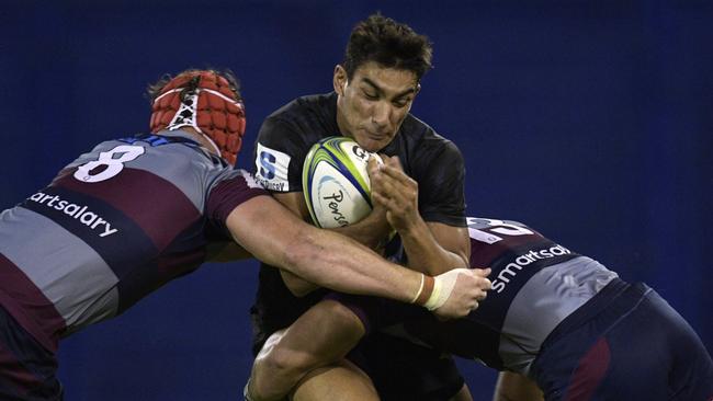 Jaguares fullback Santiago Carreras is tackled by Queensland Reds’ Harry Wilson and Hunter Paisami in Buenos Aires. Picture: AFP