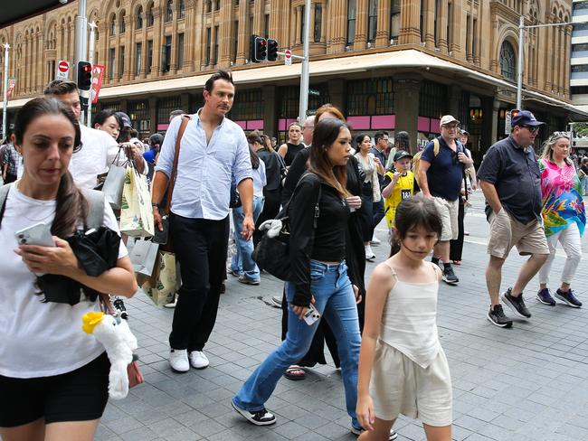 SYDNEY, AUSTRALIA : NewsWire Photos - DECEMBER 02 2024; Busy shoppers are seen walking across George Street in the Sydney CBD as Retail stores are now decorated with Christmas decorations and filled with special sales four weeks till Christmas. Picture: NewsWire / Gaye Gerard