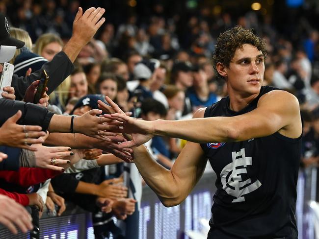 MELBOURNE, AUSTRALIA - APRIL 07: Charlie Curnow of the Blues high fives fans after winning the round four AFL match between North Melbourne Kangaroos and Carlton Blues at Marvel Stadium, on April 07, 2023, in Melbourne, Australia. (Photo by Quinn Rooney/Getty Images)