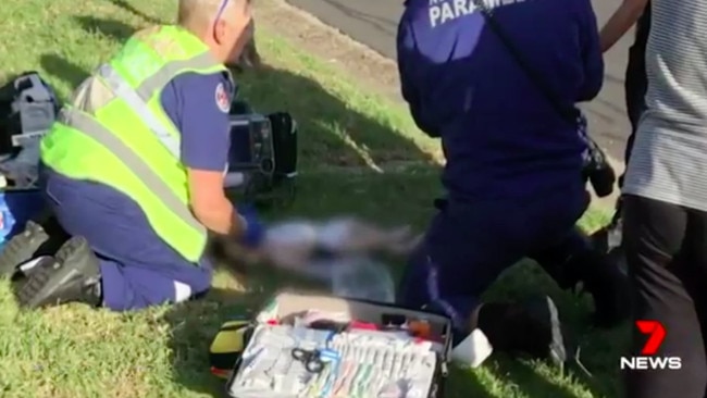 The child lay lifeless on the grass along a Lurnea street. Source: 7News