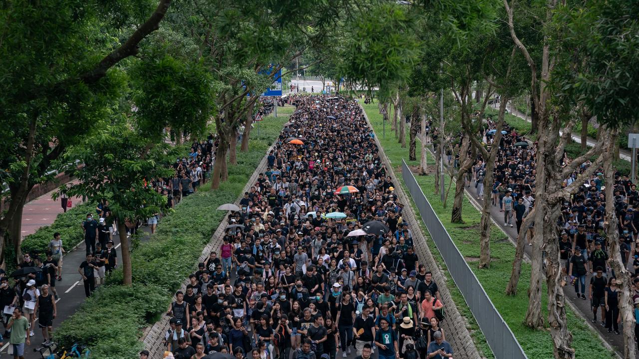 Demonstrators march during a protest in the Tseung Kwan O district yesterday. Picture: AFP