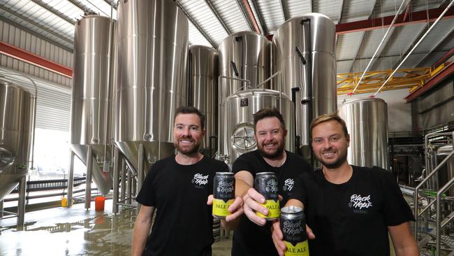 Dan Norris, Michael "Govs" McGovern, and Eddie Oldfield toast their success. Picture Glenn Hampson.