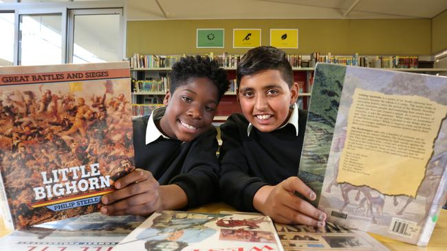 East Hills Boys High students Sekou Sesay and Hasan Mehdi, both 12 years, with some of the books they have been reading for the Premier Reading Challenge..Picture: Robert Pozo