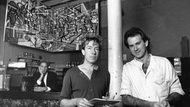 Artist Andrew Petrusivic, centre, in front of one of his paintings with Rodin Genoff, right, at Club Foote during the 1988 Adelaide Festival of Arts. Picture: Hugh Hartshorne