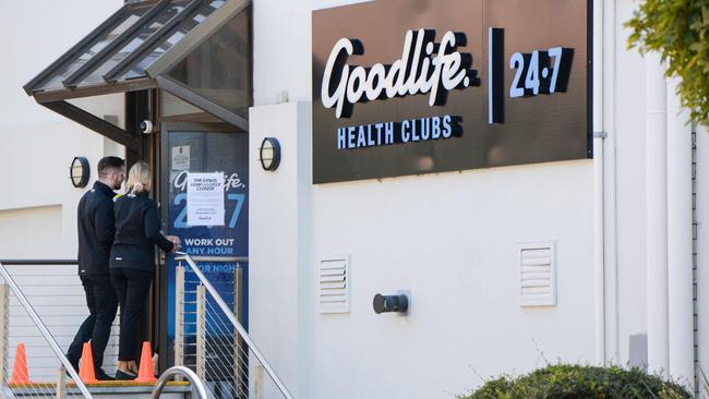 Staff enter the Goodlife gym at Mitcham after it closed to the public due to coronavirus restriction. Picture: AAP / Brenton Edwards