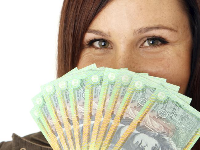 Woman with Australian currency. Picture: iStock To go with quesion: Should I discuss expected salary in my first interview?