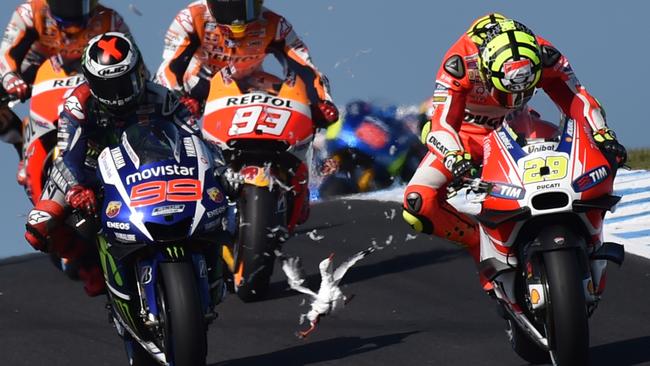 Andrea Iannone is forced out of his seat after the seagull hit. Picture: AFP.