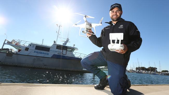 Fisheries officer Josh Smith with one of the drones they’re using to catch poachers. Picture: Tait Schmaal