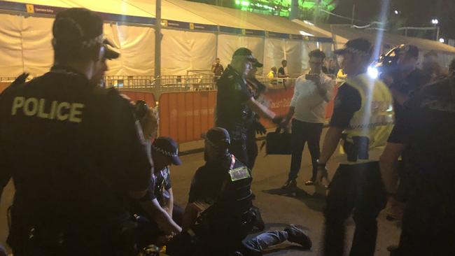 Aboriginal protesters are arrested by police at the Commonwealth Games opening ceremony. Picture: Britt Ramsey