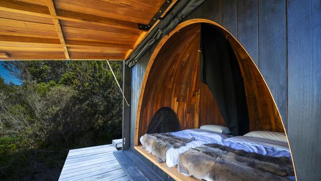 On a guided walk around the Bay of Fires guests stay in traditional Palawa-inspired domed huts. Picture: Tourism Australia