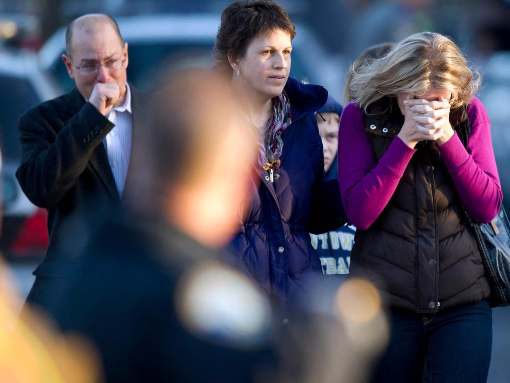 In this file photo taken on December 14, 2012, distraught people leave the fire station after hearing news of their loved ones caught up in the Sandy Hook Elementary School shooting. Picture: AFP