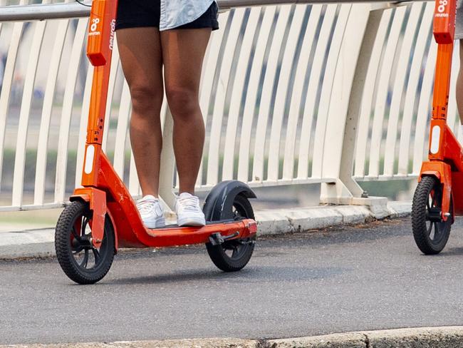 EMBARGO FOR TWAM 29 MAY 2021 People riding Neuron e-scooters through Brisbane, Sunday, December 22, 2019 (AAP Image/Richard Walker)