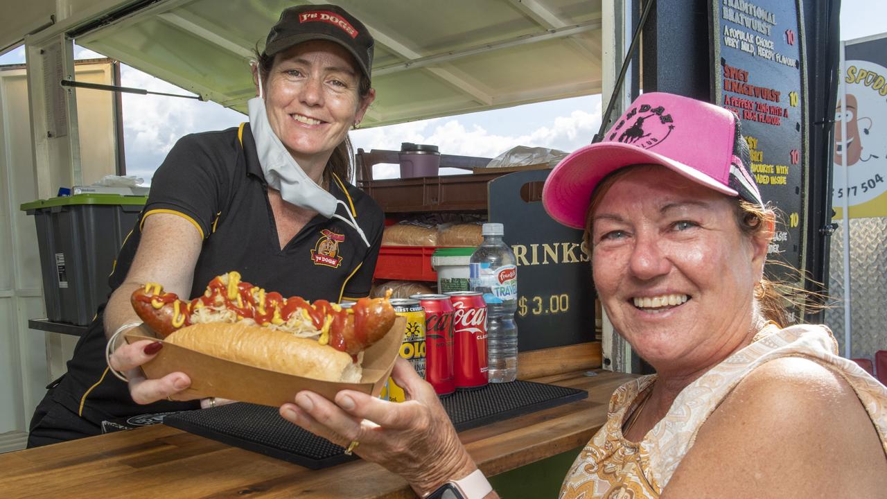 Emma Tomlinson from J's Dogs sells a german sausage to pittsworth local Teresa Minnett at the Toowoomba Street Food Festival at Pittsworth. Saturday, January 29, 2022. Picture: Nev Madsen.