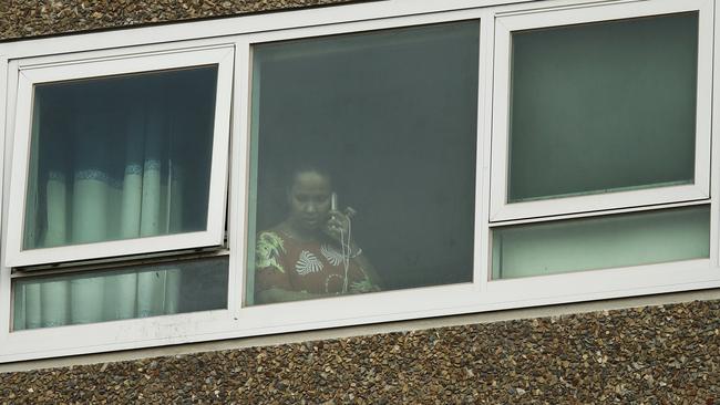 A resident at a window of the locked down public housing towers in North Melbourne. Picture: NCA NewsWire