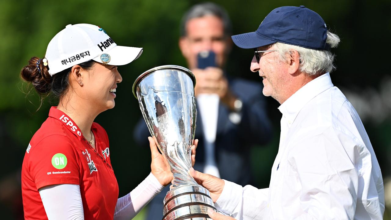 Minjee Lee is presented with her trophy by Franck Riboud. (Photo by Stuart Franklin/Getty Images)