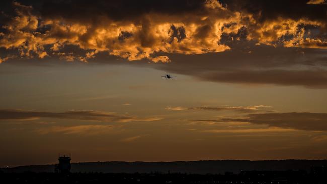 A plane over Adelaide Aiport at sunrise earlier this year. Picture: AAP / Mike Burton