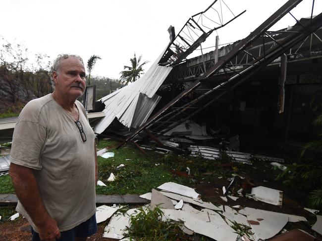 Dave Mcinnerney inspects the damage to his motel at Shute Harbour, Airlie Beach. Picture: Dan Peled/AAP