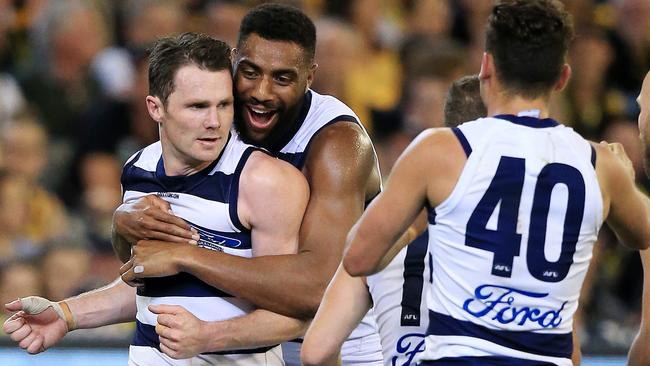 Patrick Dangerfield celebrates a goal with teammate Esava Ratugolea.