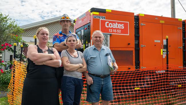 Kerri Mason, Kerrie Dowd, Pat Wilcocks and George Pawlowski with one of the eight generators that have been supplying power to the flood damaged Kamerunga Villas. Picture: Emily Barker