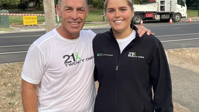 North Melbourne and AFL premiership coach Alistair Clarkson with Delaney Troon who is running 21 half marathons in 21 days. Picture: Shane Jones.