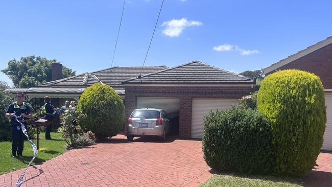 Police investigate the scene where Mr Quilliam allegedly drove into a house in Dunwinnie Court in Hamlyn Heights.