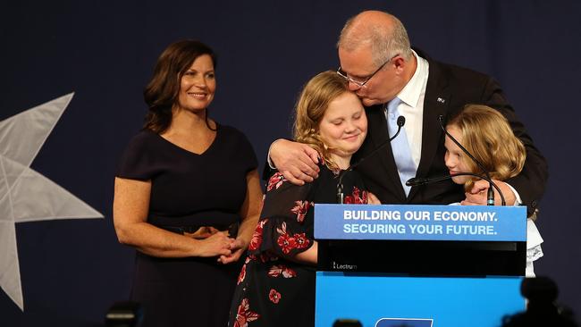 The Prime Minister embraces his daughters as wife Jenny looks on. Picture: Sam Ruttyn