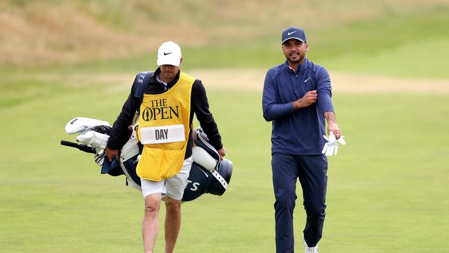 Jason Day of Australia walks with his caddie on the 18th hole. Picture: Getty Images