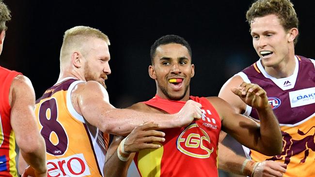 Robertson (left) gets into Gold Coast’s Touk Miller. Pic: AAP