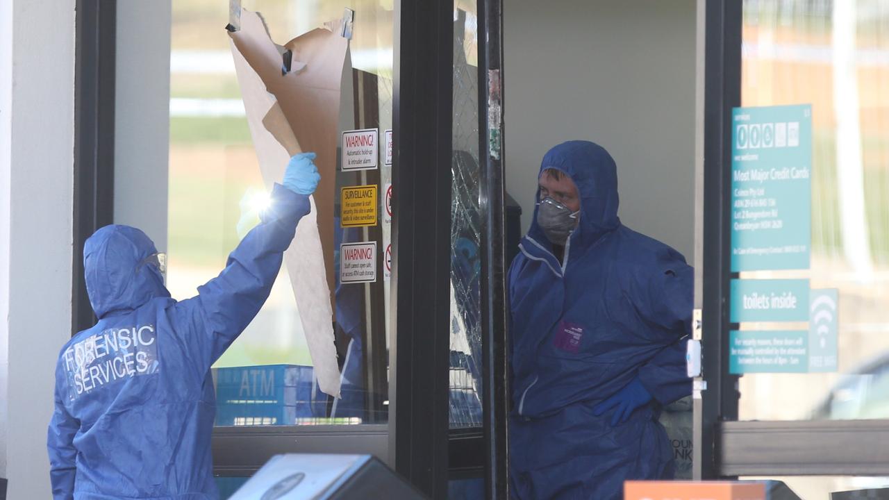 Police examine the Caltex services station in Queanbeyan where Mr Akbar was fatally stabbed. Picture Kym Smith