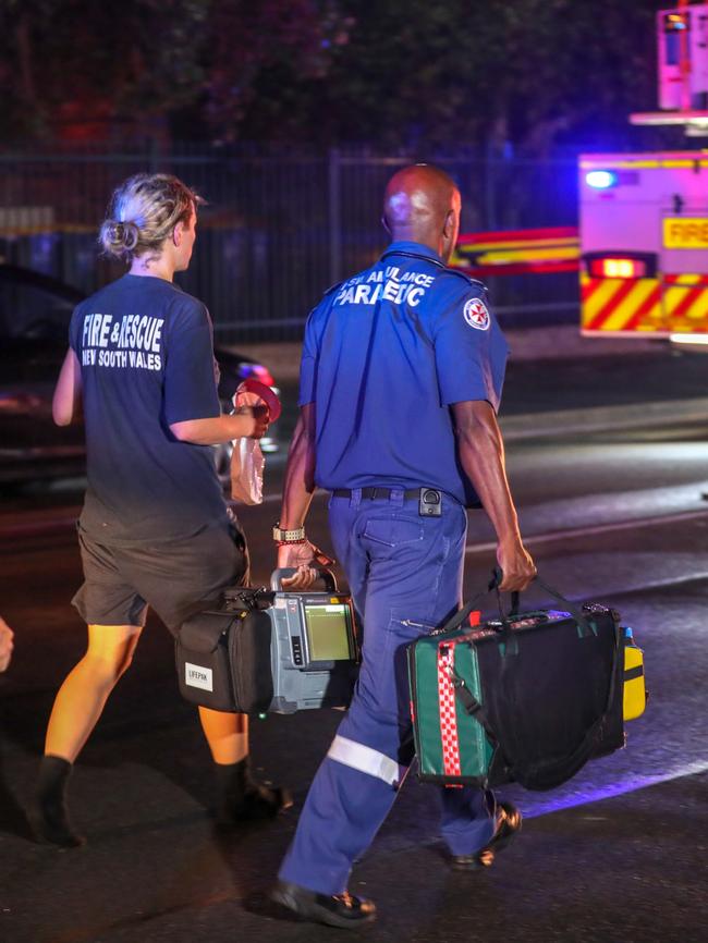 Paramedics walking to treat firefighters. Picture: Dead Asher