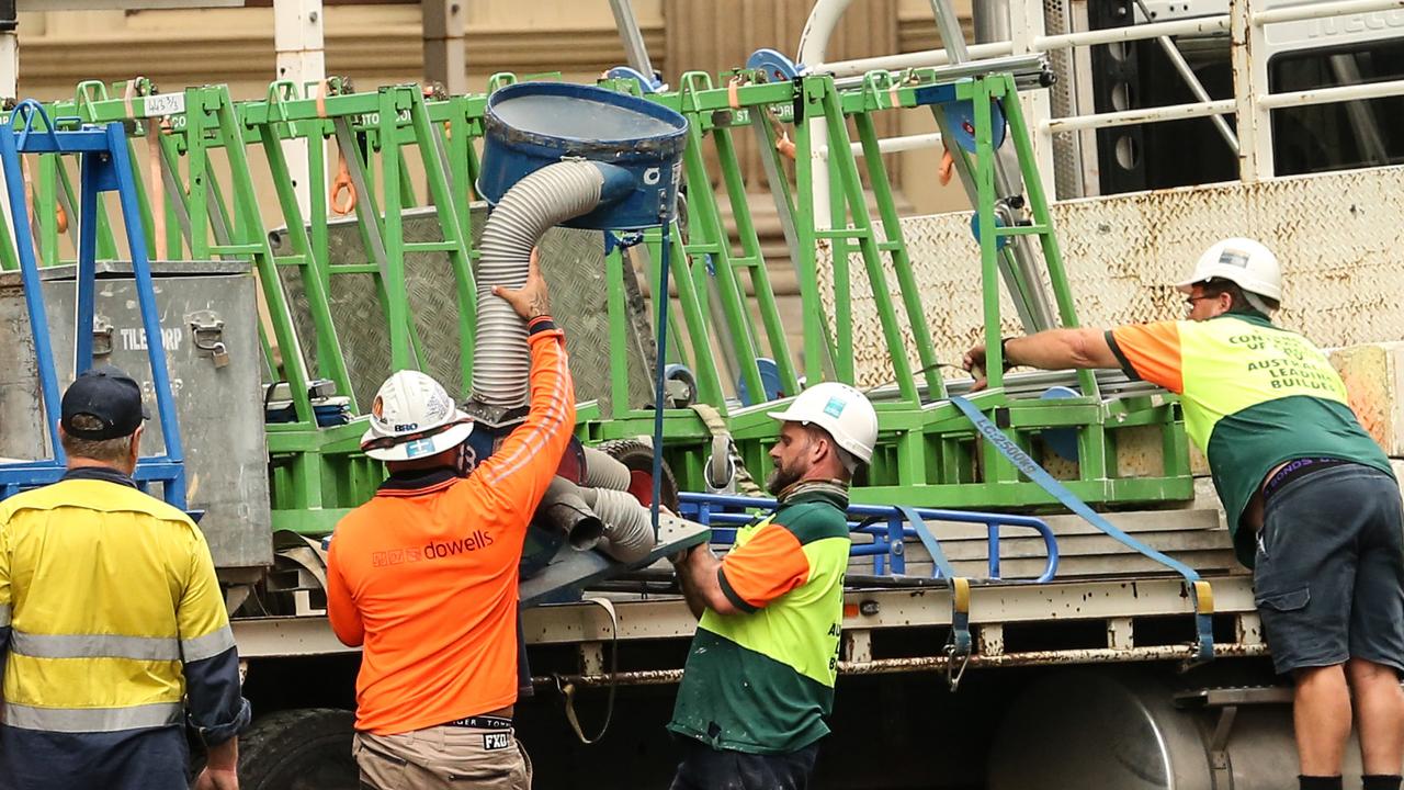 Workers leave the Probuild worksite on 443 Queens Street. Picture: Zak Simmonds