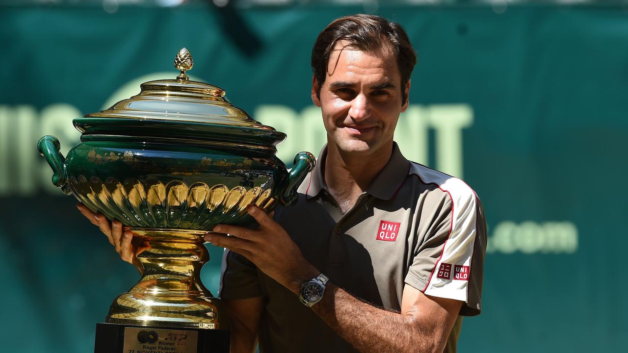 Roger Federer from Switzerland poses with the Halle trophy.