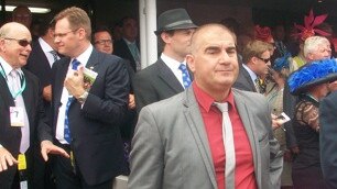 Bill Vlahos, red shirt, in the mounting yard at Flemington on Melbourne Cup Day 2012.
