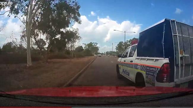 A cop car has narrowly avoided colliding with a Darwin motorist on the Stuart Hwy. Video: Brett Perry