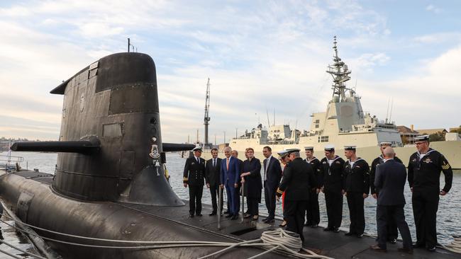 French President Emmanuel Macron (2nd L) and Australian Prime Minister Malcolm Turnbull (3rd L) stand on the deck of HMAS Waller, a Collins-class submarine operated by the Royal Australian Navy. Picture: AFP