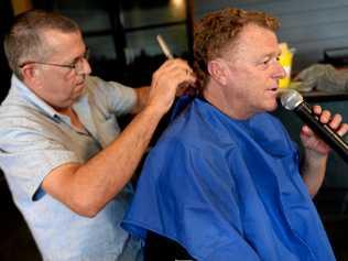 Mark West gives Peter Lynch's mullet the chop to raise funds for a sick child. Picture: Jann Houley