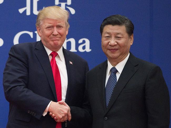 (FILES) In this file photo taken on November 8, 2017 US President Donald Trump (L) and China's President Xi Jinping shakE hands during a business leaders event at the Great Hall of the People in Beijing. - US President Donald Trump, who is seeking reelection on November 3, has regularly jolted the world with statements about other leaders that sharply deviate from long-held diplomatic protocol. (Photo by Nicolas ASFOURI / AFP) / TO GO WITH US-vote-diplomacy-trade-China,FOCUS by Patrick Baert