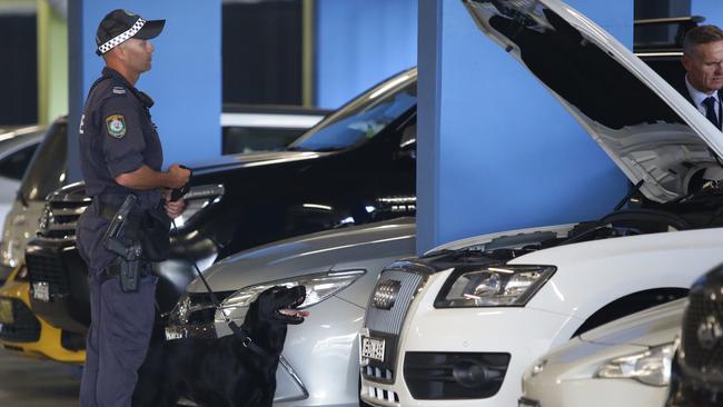 Police examine several cars in the parking garage of Abuzar Sultani’s Olympic Park apartment building in December, 2016. Picture: Craig Wilson