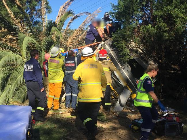 Emergency crews work to free the driver. Picture: CareFlight