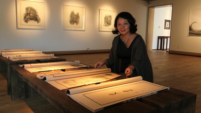 Artist Tao Aimin’s works on rice paper combine ink rubbings of washboards and Nushu script.