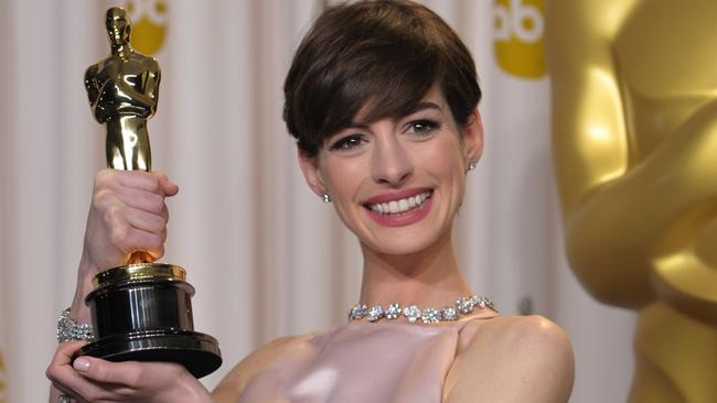 Anne Hathaway poses with her Oscar for best actress in a supporting role in 2013.
