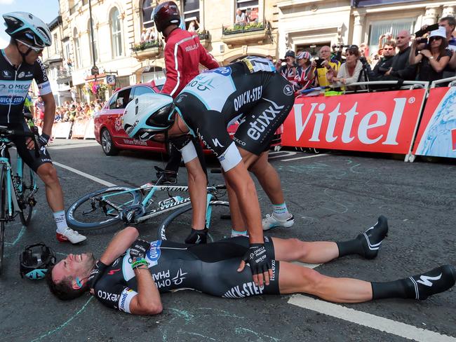 Mark Cavendish lies prone on the tarmac after colliding with Australian cyclist Simon Gerrans.