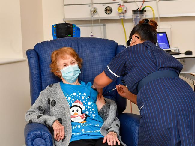 CORRECTION - Nurse May Parsons (R) administers the Pfizer/BioNtech Covid-19 vaccine to Margaret Keenan (L), 90, at University Hospital in Coventry, central England, on December 8, 2020 making Keenan the first person to receive the vaccine in the country's biggest ever immunisation programme. - Britain on December 8 hailed a turning point in the fight against the coronavirus pandemic, as it begins the biggest vaccination programme in the country's history with a new Covid-19 jab. (Photo by Jacob King / POOL / AFP) / âThe erroneous mention[s] appearing in the metadata of this photo by Jacob King has been modified in AFP systems in the following manner: Pictures were taken on [December 8, 2020] instead of [December 9, 2020]. Please immediately remove the erroneous mention[s] from all your online services and delete it (them) from your servers. If you have been authorized by AFP to distribute it (them) to third parties, please ensure that the same actions are carried out by them. Failure to promptly comply with these instructions will entail liability on your part for any continued or post notification usage. Therefore we thank you very much for all your attention and prompt action. We are sorry for the inconvenience this notification may cause and remain at your disposal for any further information you may require.â