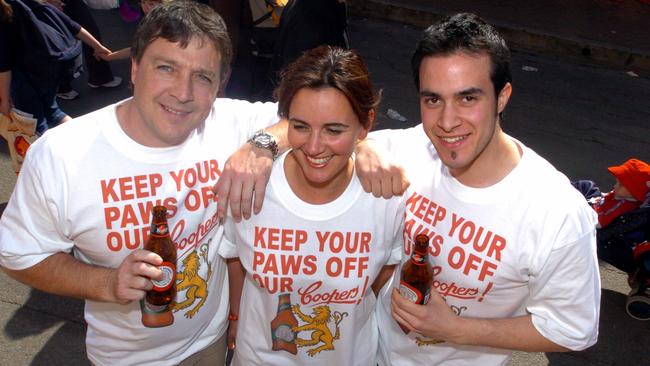 Coopers t-shirts made in response to the recent Lion Nathan takeover bid. The t-shirts are for sale at the Royal Adelaide Show. (L-r) are John Worral, 39, Kirsty Coleman, events manager for Topline Promotions and Vincent Tarzia, 18,