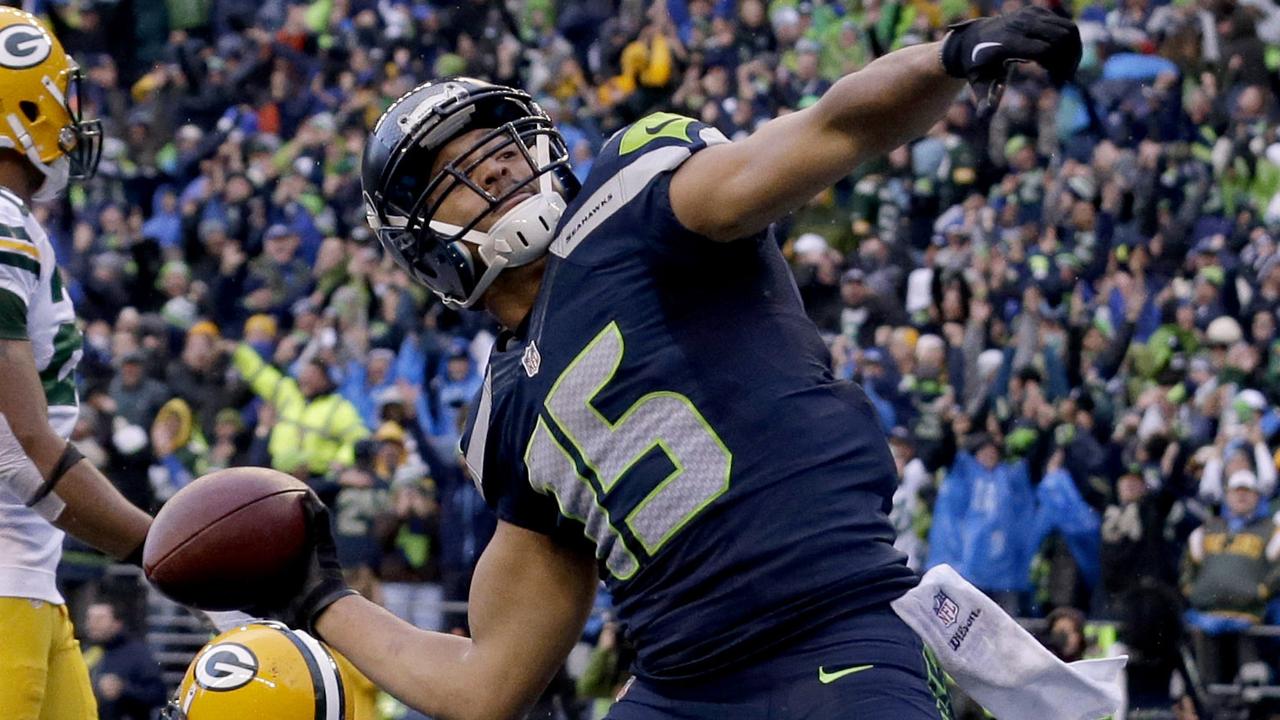 FILE - In this Sunday, Jan. 18, 2015, file photo, Seattle Seahawks wide receiver Jermaine Kearse (15) throws the ball into the stands after scoring the game-winning touchdown against the Green Bay Packers during overtime of the NFC championship NFL football game in Seattle. Kearse was having an NFC championship game to forget until the final play. That's when the Seahawks receiver added yet another memorable postseason touchdown to his resume. (AP Photo/Jeff Chiu, File)
