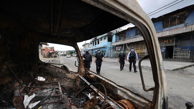 Australian Federal Police inspect burnt out areas of China Town in Honiara.