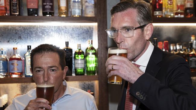 Premier Dominic Perrottet (R) and Deputy Premier Paul Toole drink a beer before holding a media conference on October 11. Picture: Brook Mitchell/Getty Images