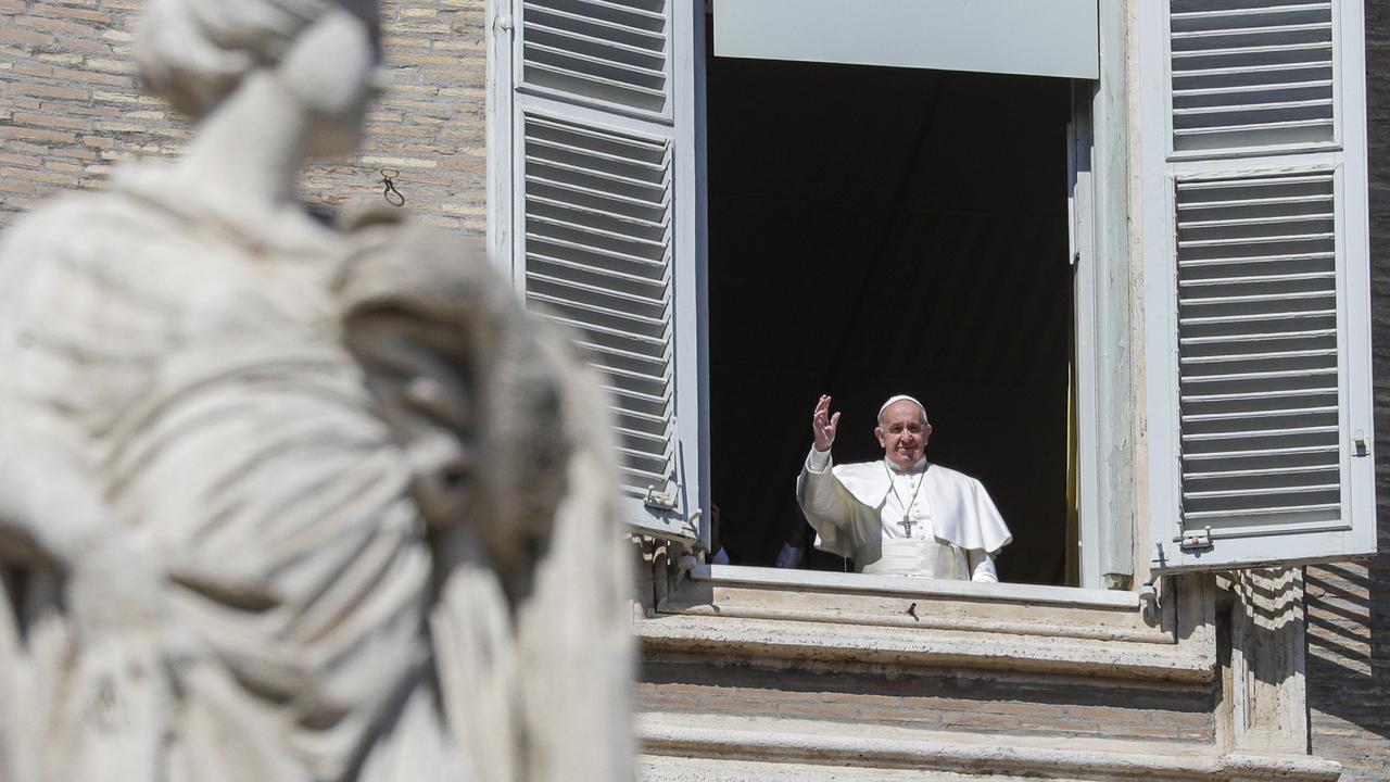 Pope Francis waves briefly from his window overlooking St Peter's Square after delivering the Angelus prayer on a giant screen on Sunday, March 8. Picture: AP/Andrew Medichini